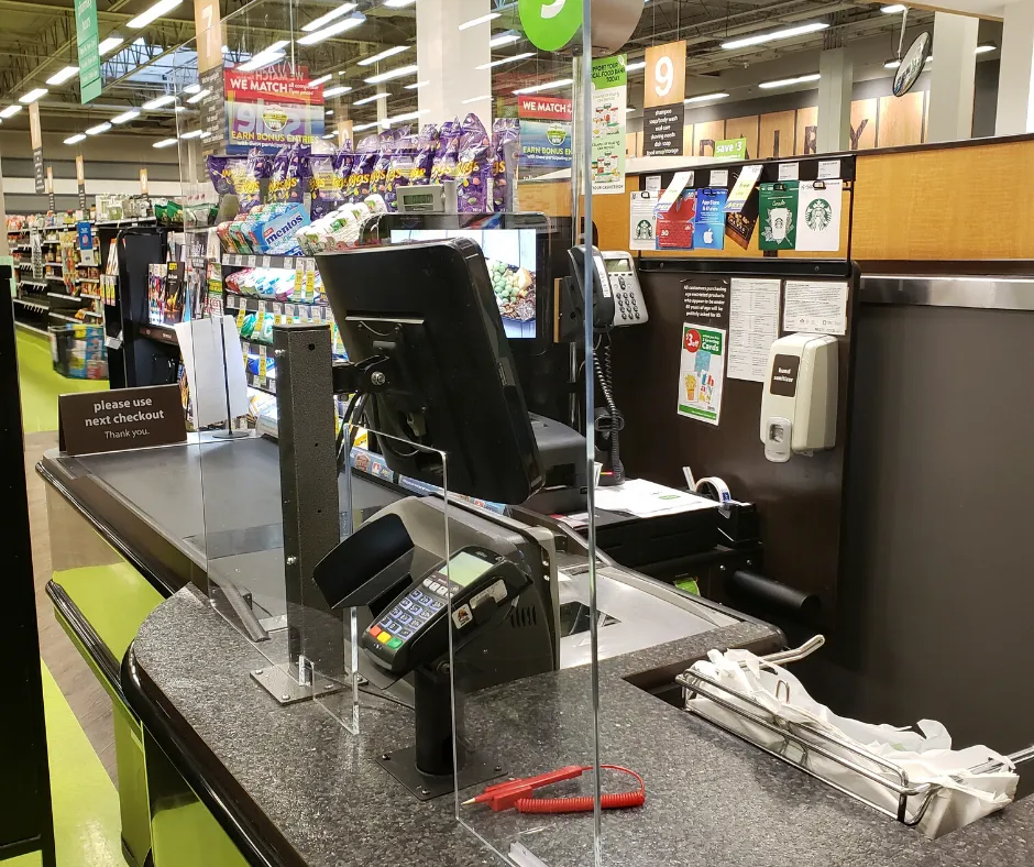 Clear acrylic counter shield at a checkout