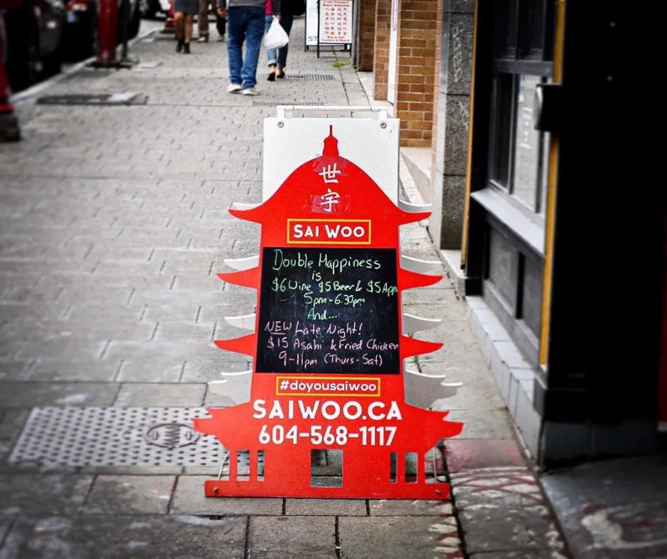 Custom cut red sandwich board on a sidewalk