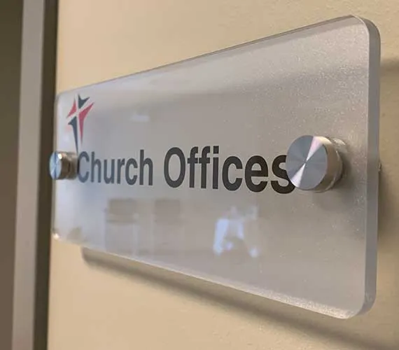 Frosted acrylic door sign on brushed standoffs