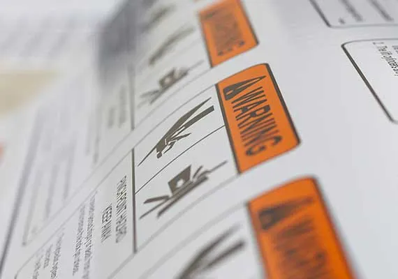 Close-up of orange OEM warning decals