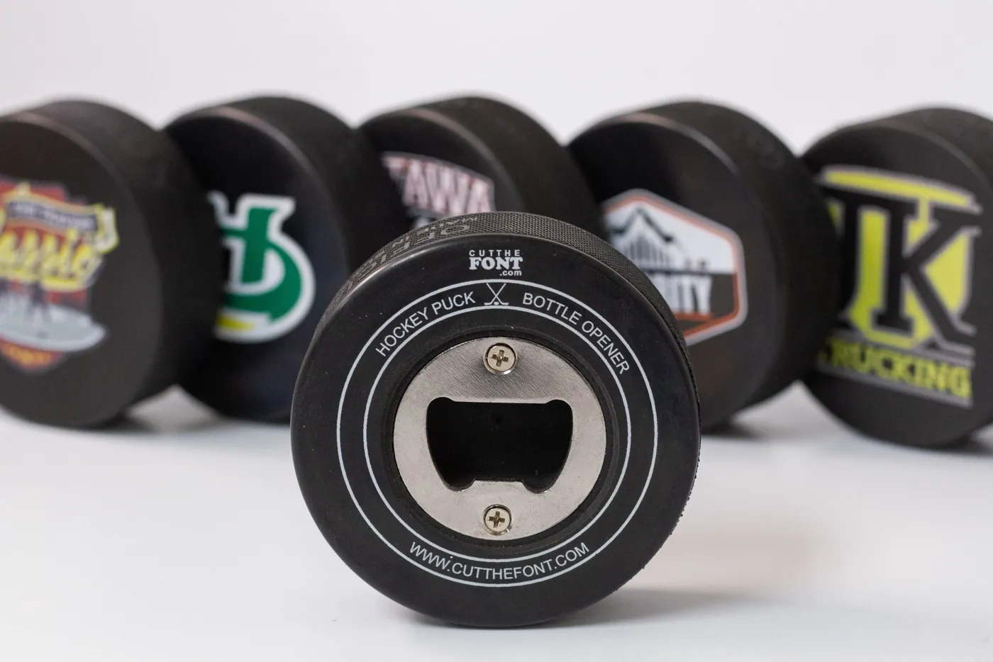 Hockey puck bottle openers with custom prints
