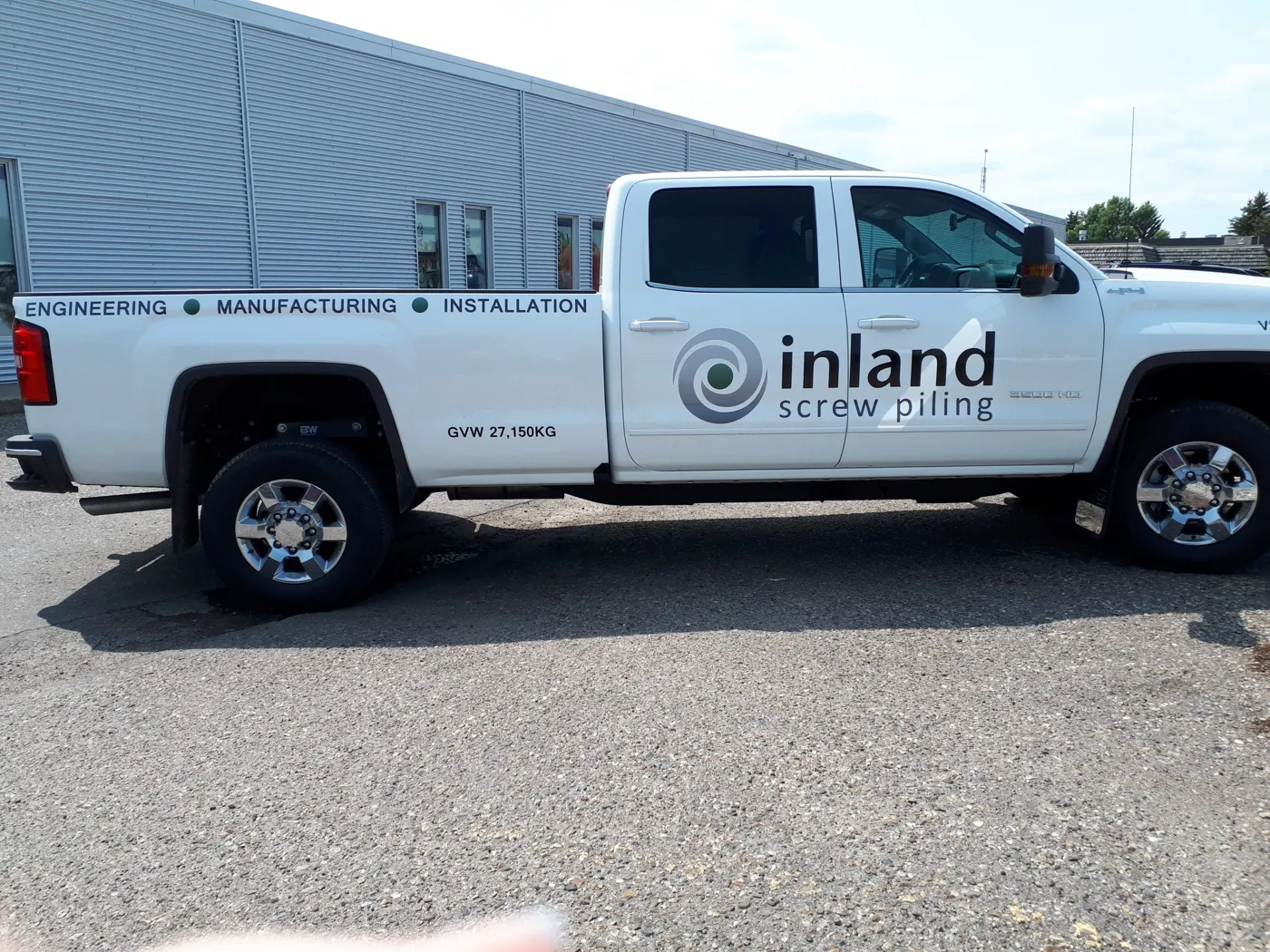 Cut vinyl lettering on a white pickup truck